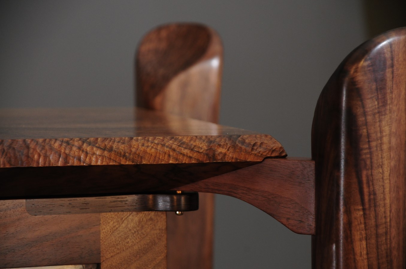 Detail of chip carved top and bridge to legs